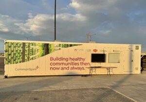 An image of a container farm with CommonSpirit branding on the outside. This farm is in the Globeville Elyria Swansea area of Denver.