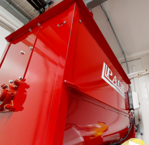 A red ribbon mixer used for creating mushroom substrate.